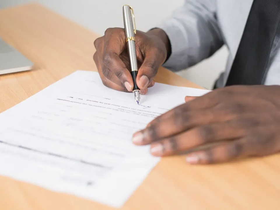 Contract paperwork and a pen on a desk