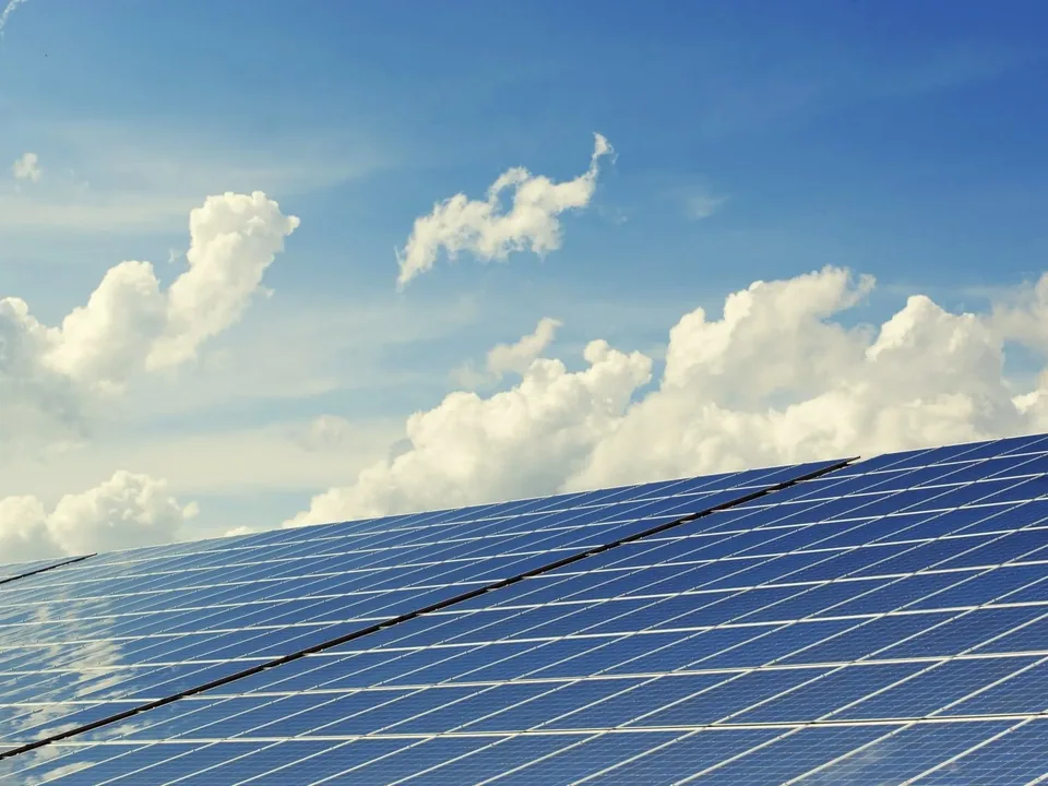 Rows of solar panels under a clear sky